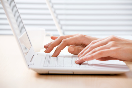 Female hands on laptop